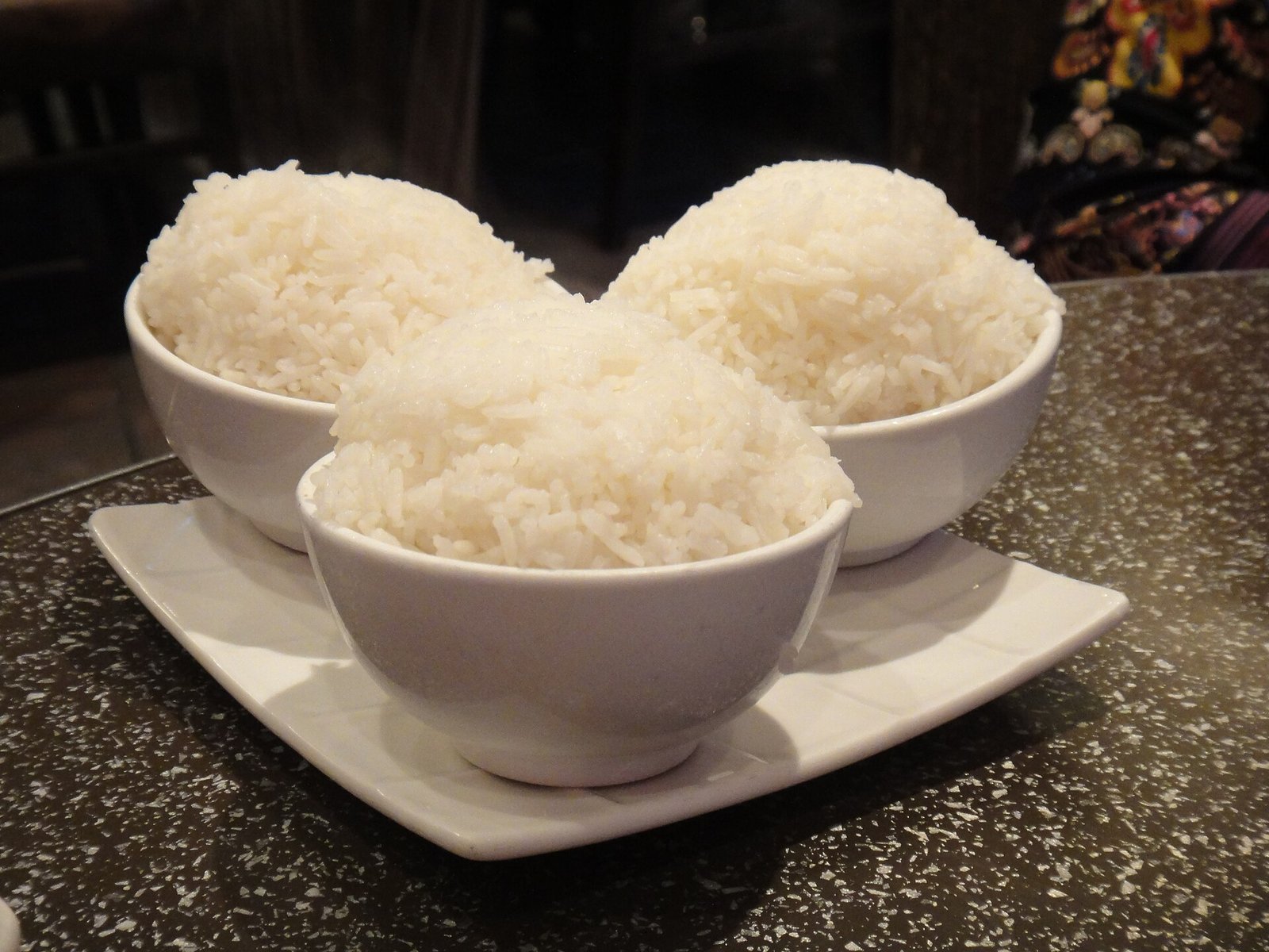 Three bowls of steamed white rice ready to serve