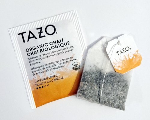 A chai tea bag beside its packet, ready to chill for puffy eyes