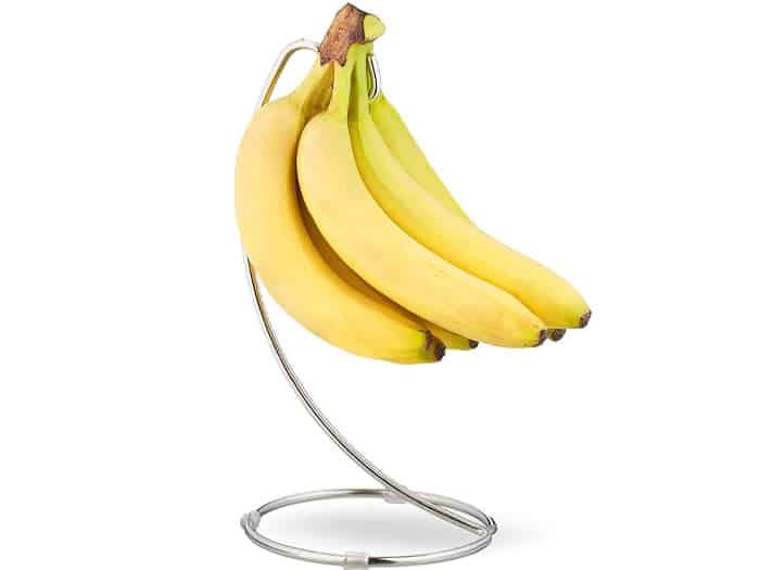 Bananas hanging on a kitchen banana hanger