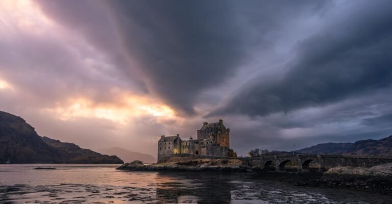 Eilean Donan Castle glowing at dusk in the Scottish Highlands, the kind of dramatic setting used for The Celebrity Traitors