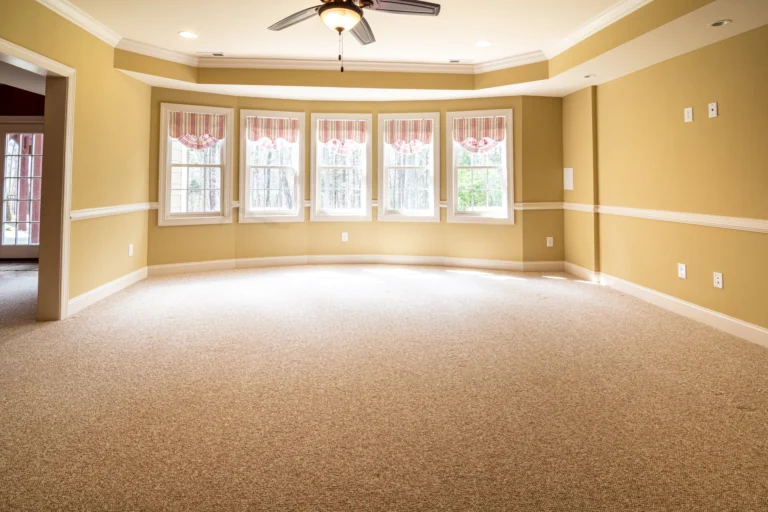 How to Stop a Squeaky Floorboard Without Removing Carpet: 7 Simple Fixes Carpeted bedroom floor with timber floorboards beneath the carpet.