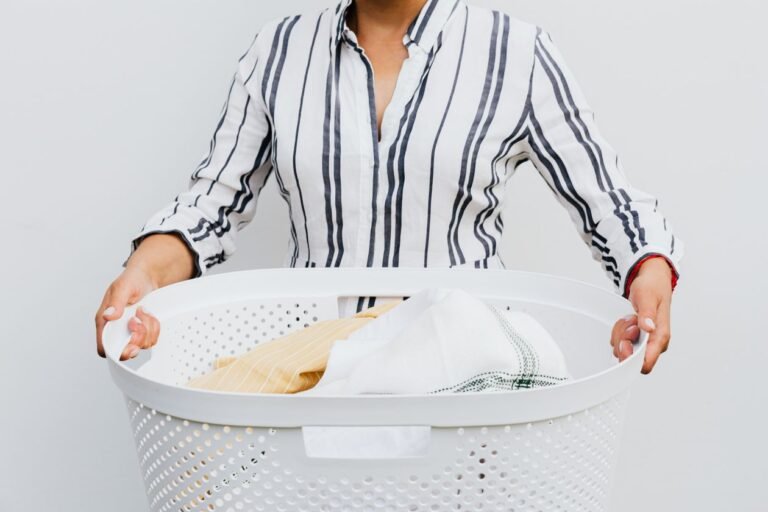 Woman holding a basket of fresh laundry in a bright laundry room