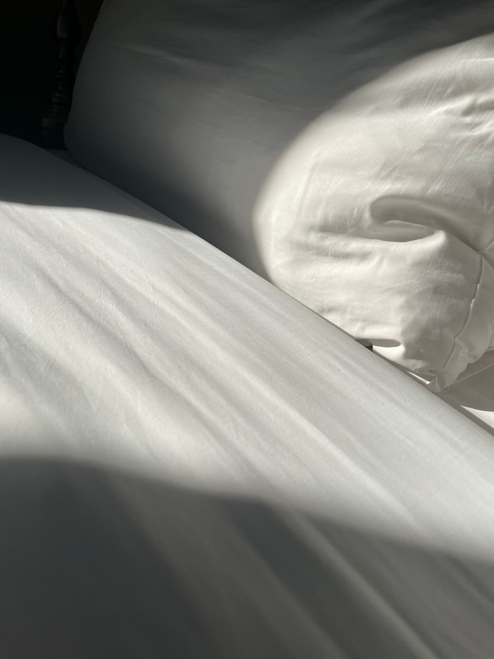 White pillows and bed sheet with a snug smooth fit