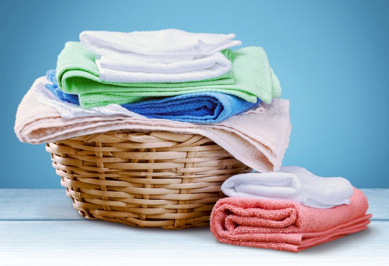 Stack of freshly dried folded towels in a laundry basket