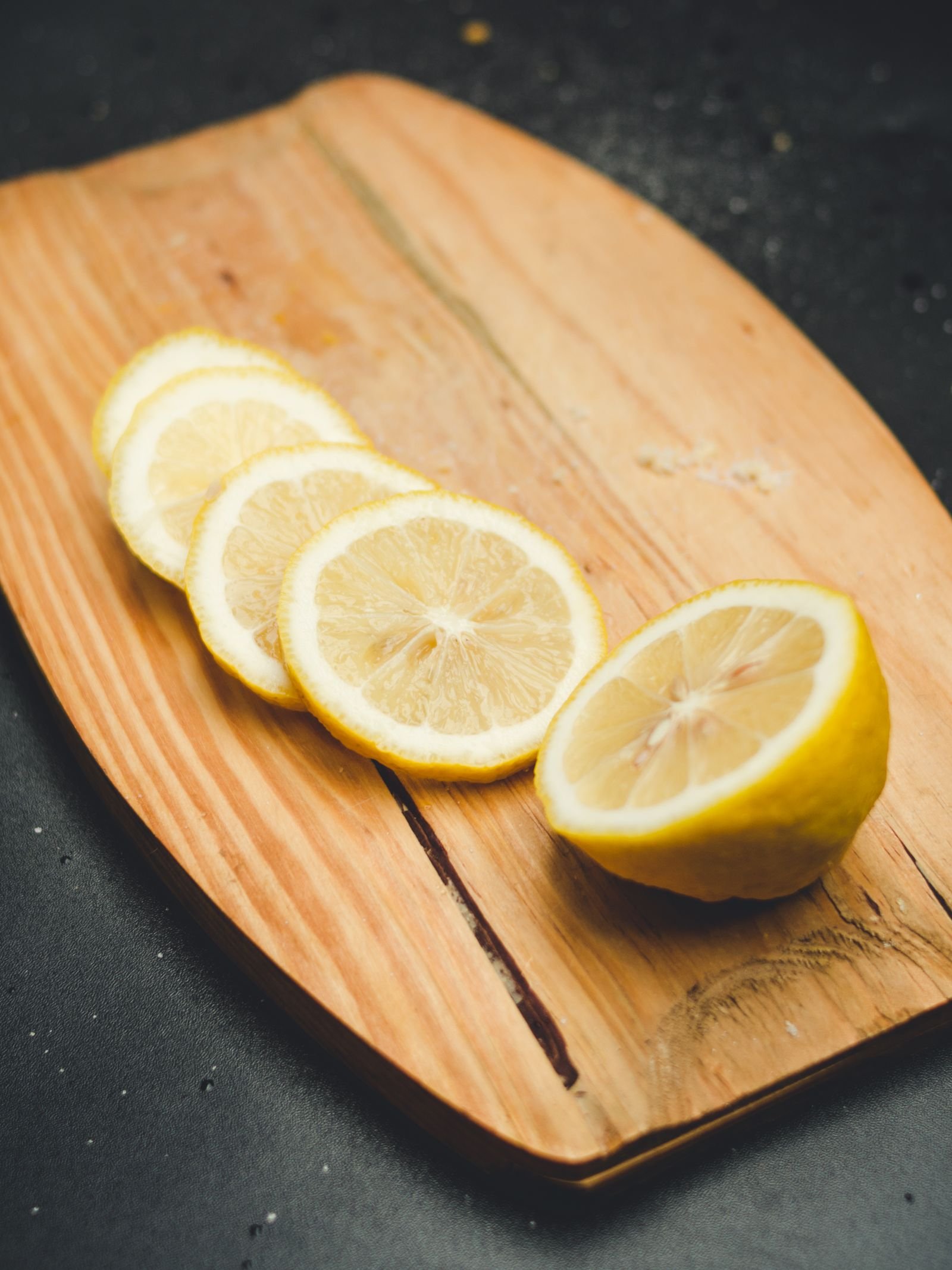 Fresh lemon slices on a wooden chopping board