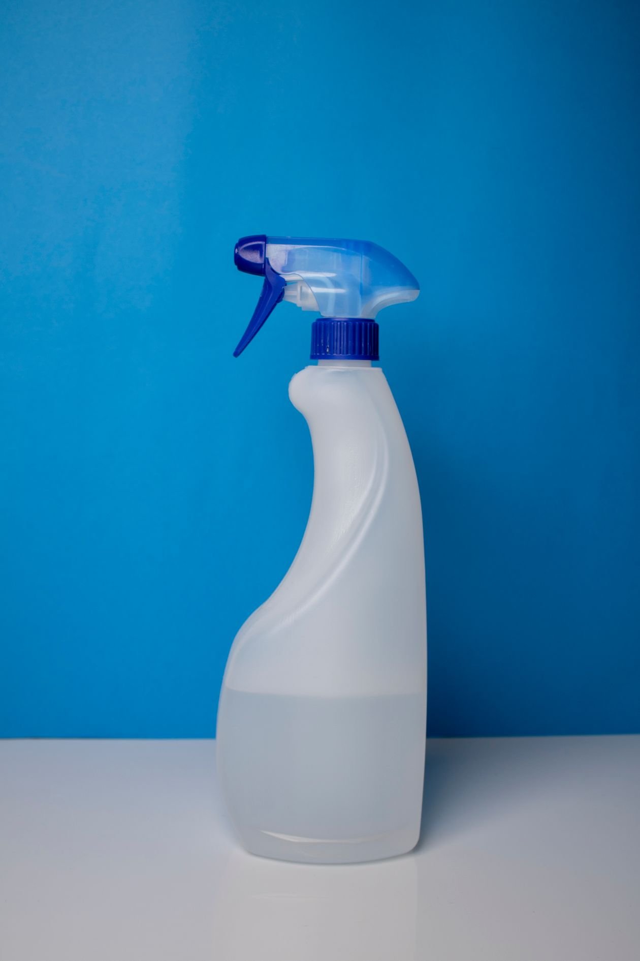 Clear spray bottle filled with a homemade vinegar and water solution