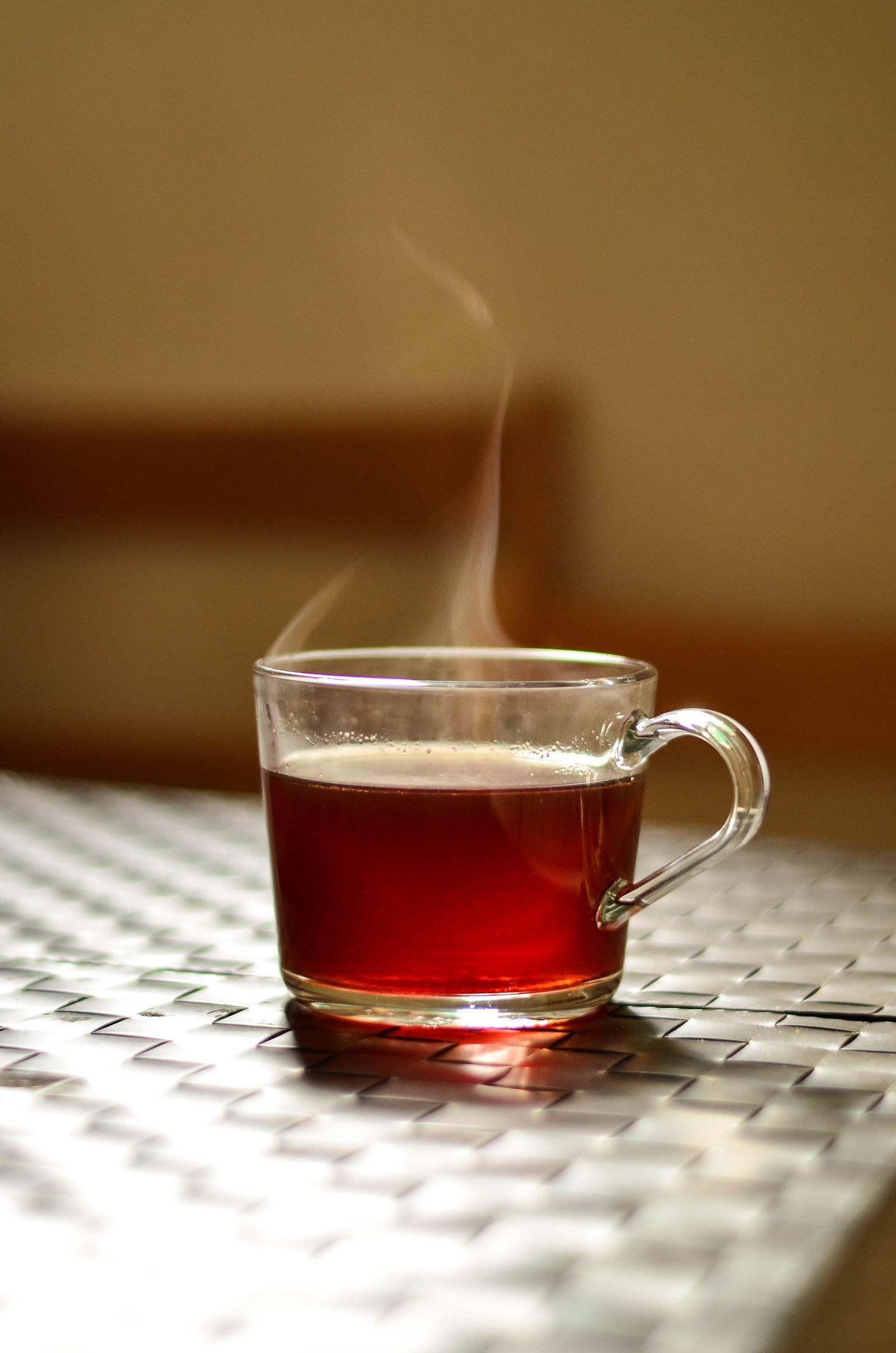 A steaming cup of tea on a kitchen table
