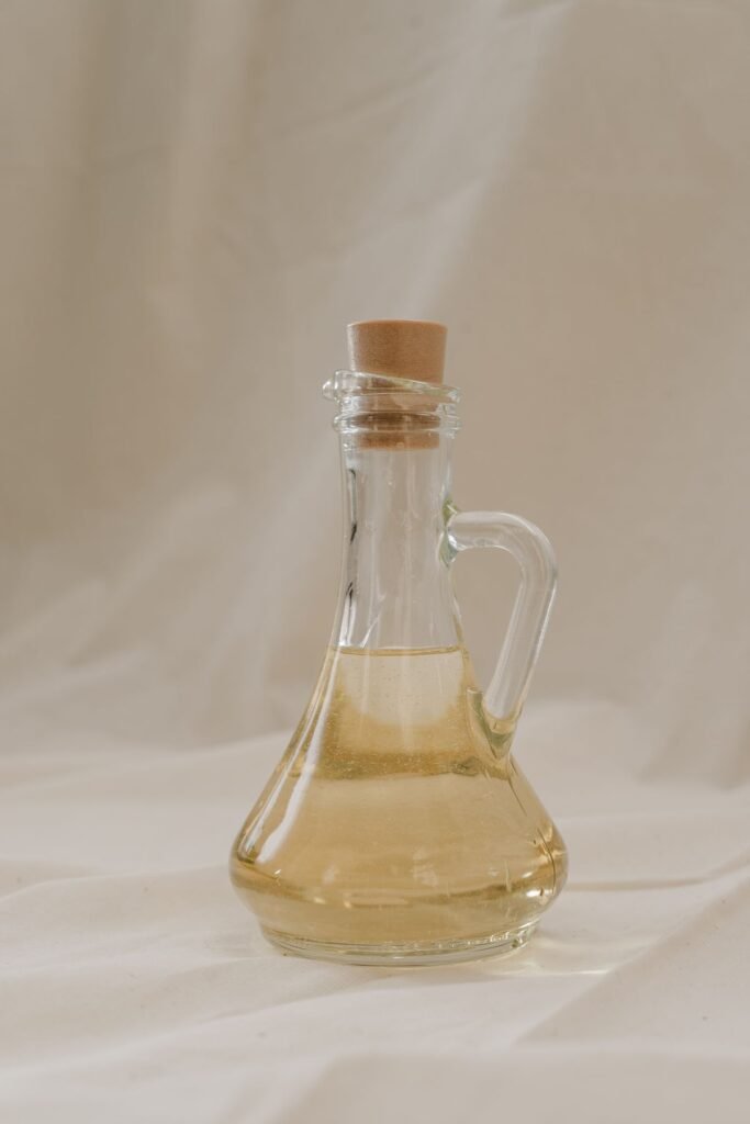Glass bottle filled with clear white vinegar