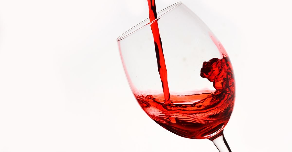 Deep red liquid pouring like homemade fake blood
