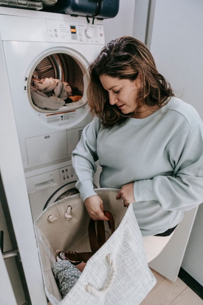 Woman loading laundry into a home washing machine