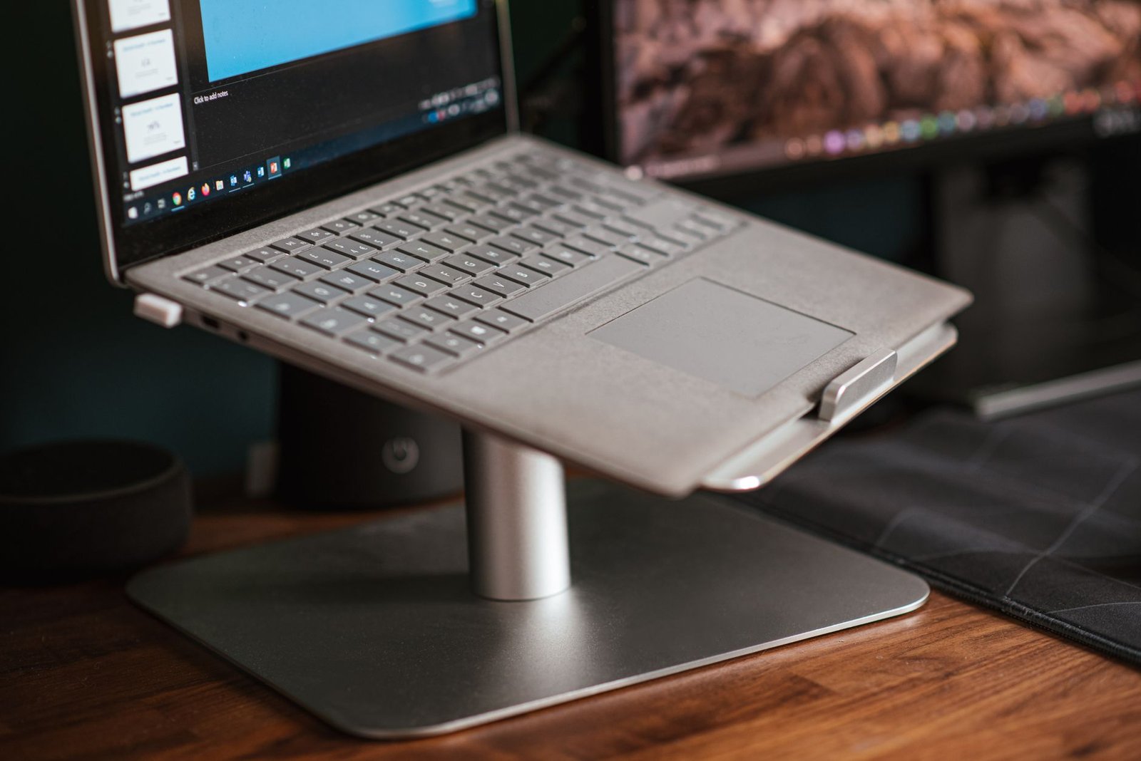 Laptop raised on a metal stand for better airflow