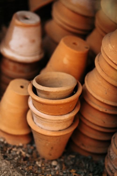 Stack of terracotta pots ready for planting edamame